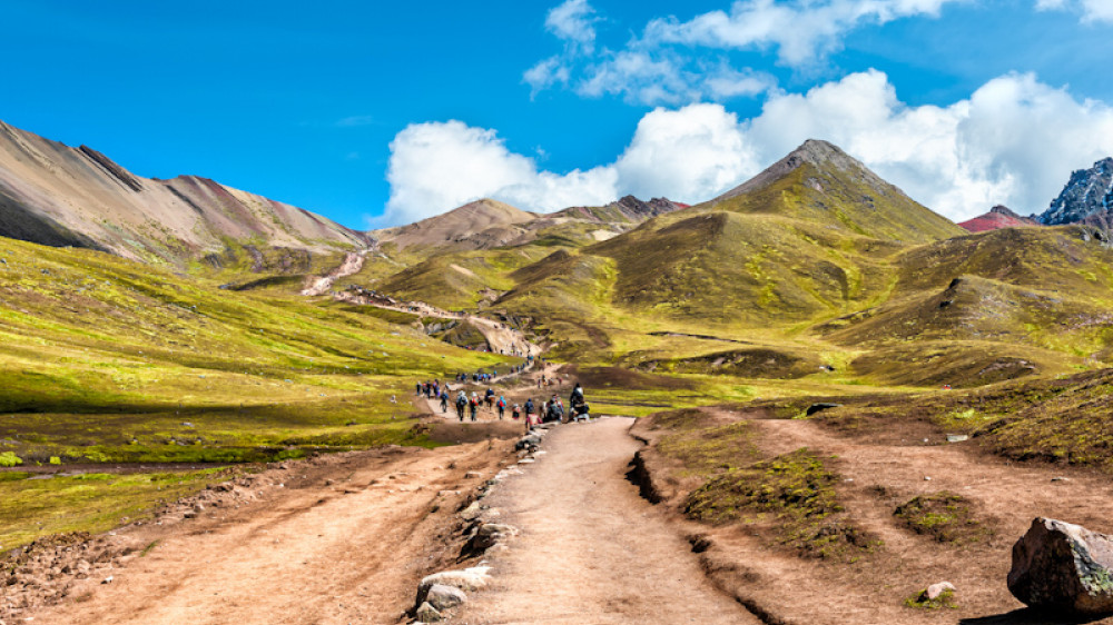 Hiking scene in Vinicunca, Cusco Region, Peru.  Rainbow Mountain (Montana de Siete Colores). (Copyright (c) 2019 May_Lana/Shutterstock.  No use without permission.)